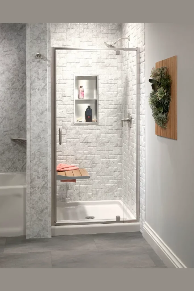 newly renovated shower with white brick like tile and chrome door
